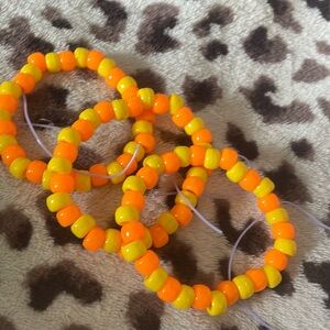 Orange and yellow bracelet there’s some purple extra string but u can cut it off